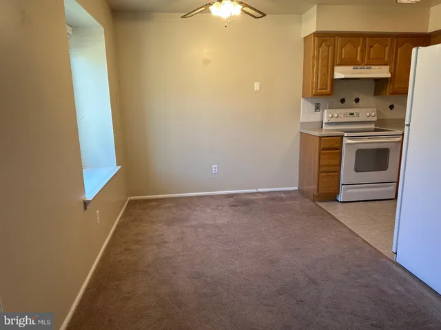 a room with a stove and a refrigerator