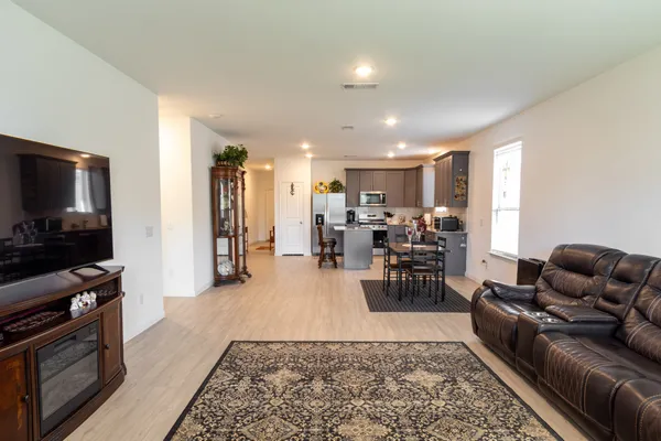 a living room with furniture wooden floor and a window