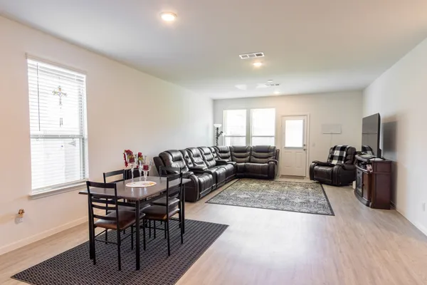 a bedroom with a bed and dresser with mirror