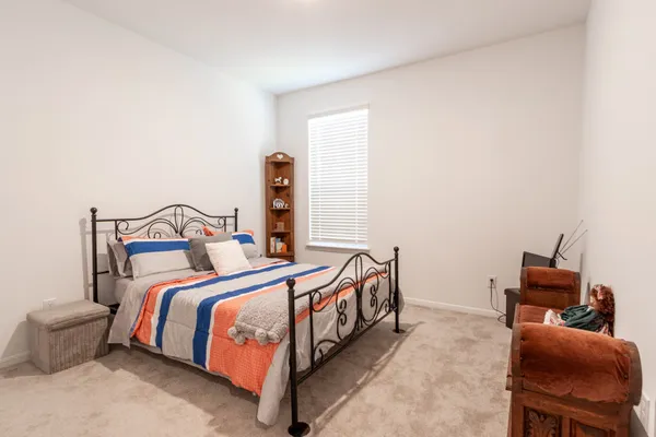 a spacious bedroom with a bed and a window