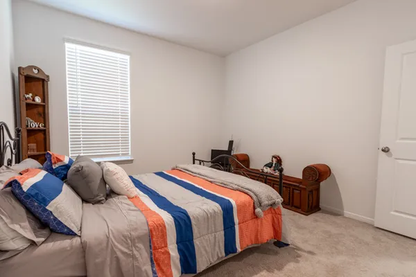 a bedroom with a bed and cabinet