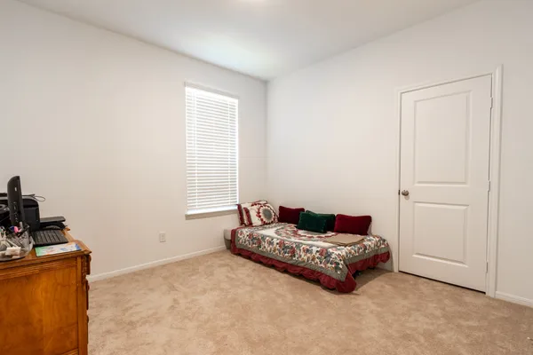 a bedroom with a bed and a television