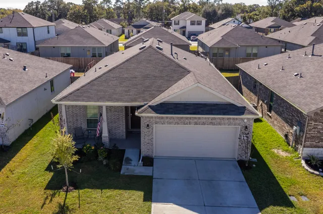 a large kitchen with kitchen island a large counter top space a sink stainless steel appliances and cabinets