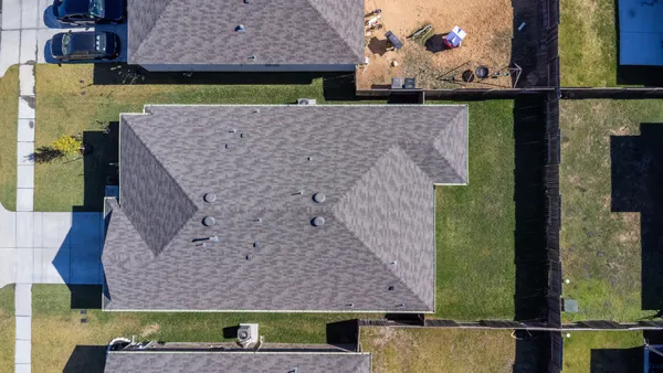 a aerial view of a house with a yard