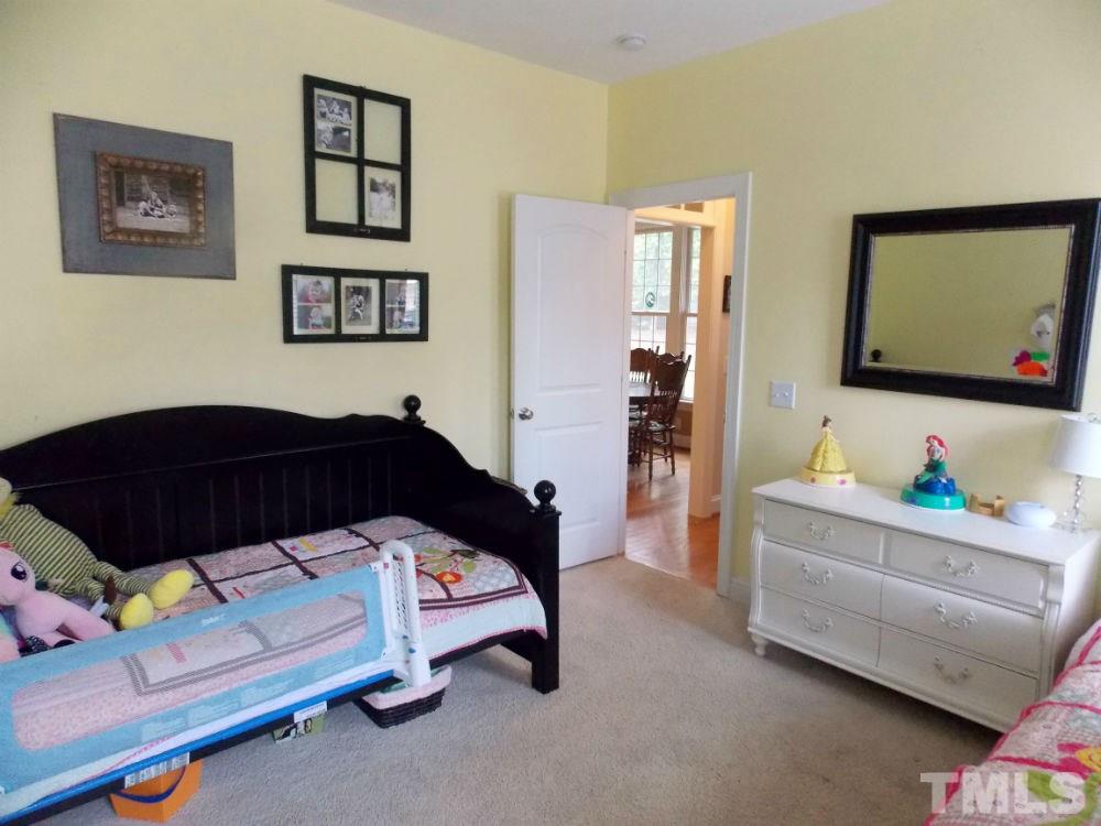 1840 Bowling Green Trail Raleigh, NC 27613 - Photo 7 of 16 a bedroom with furniture and a flat screen tv