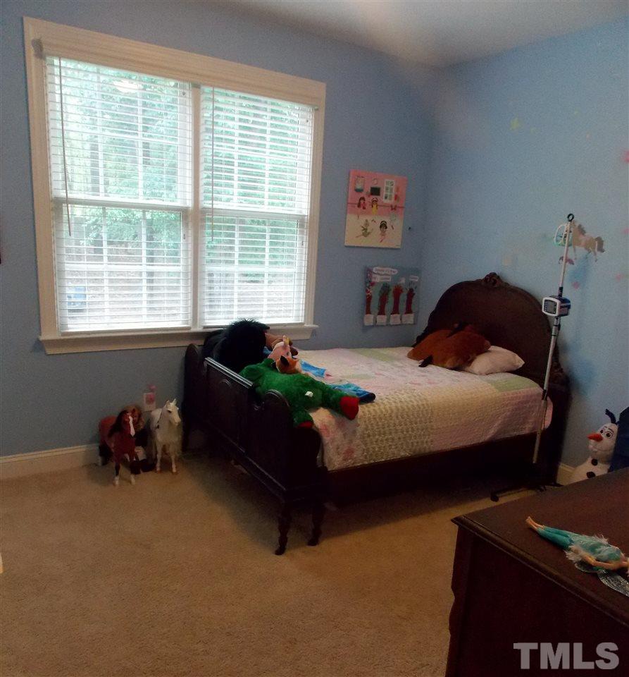 1840 Bowling Green Trail Raleigh, NC 27613 - Photo 8 of 16 a bedroom with a bed and a window