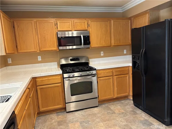a kitchen with a refrigerator stove and microwave