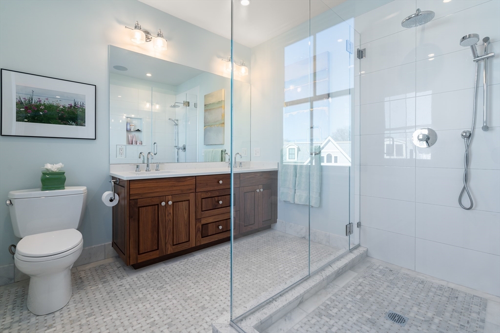 16 Everett Street, Unit 202 Boston, MA 02130 - Photo 13 of 19 a bathroom with a toilet a sink and glass door