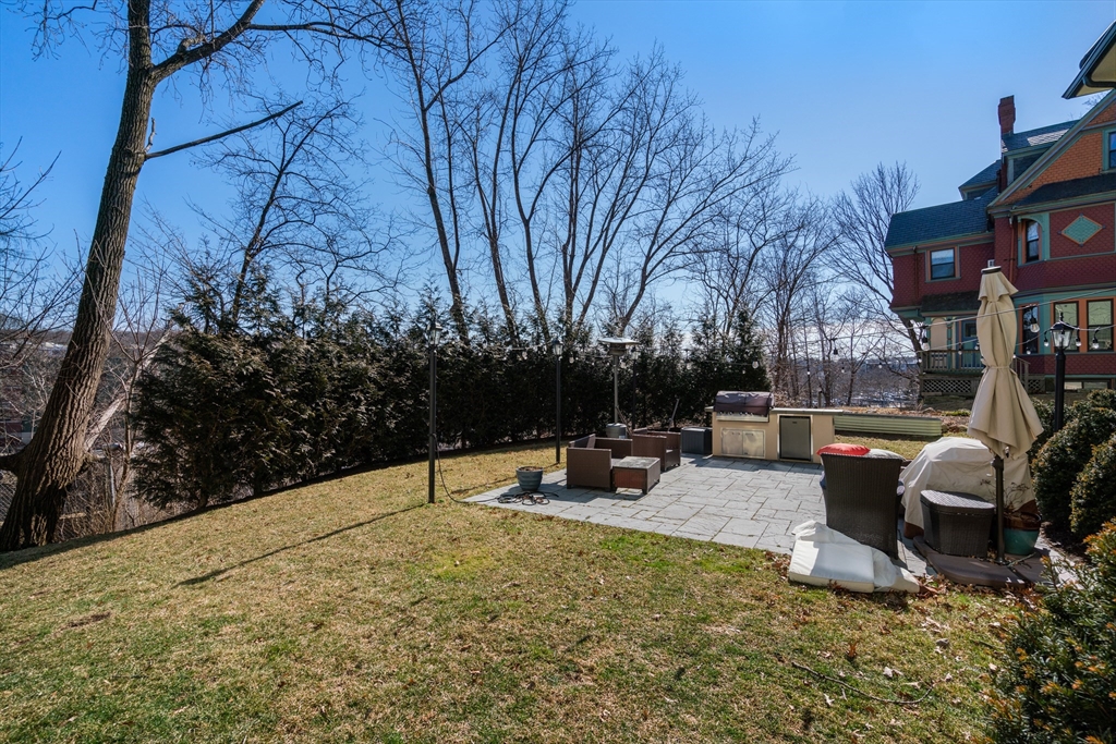 16 Everett Street, Unit 202 Boston, MA 02130 - Photo 16 of 19 a backyard of a house with fire pit and outdoor seating