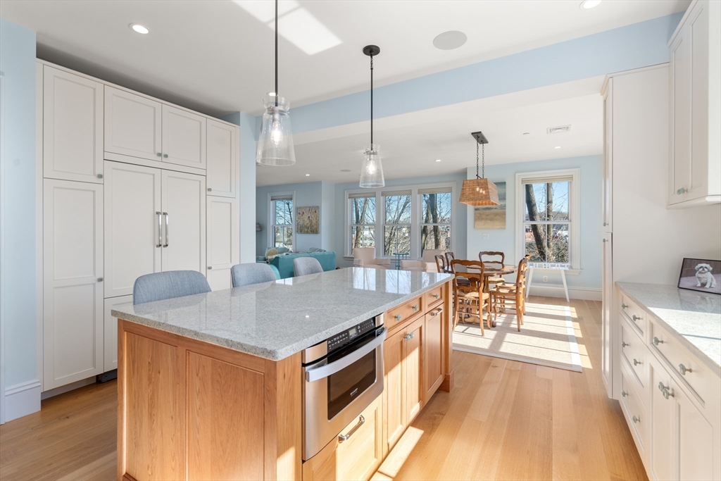 16 Everett Street, Unit 202 Boston, MA 02130 - Photo 6 of 19 a kitchen with stainless steel appliances granite countertop a stove and a wooden floors