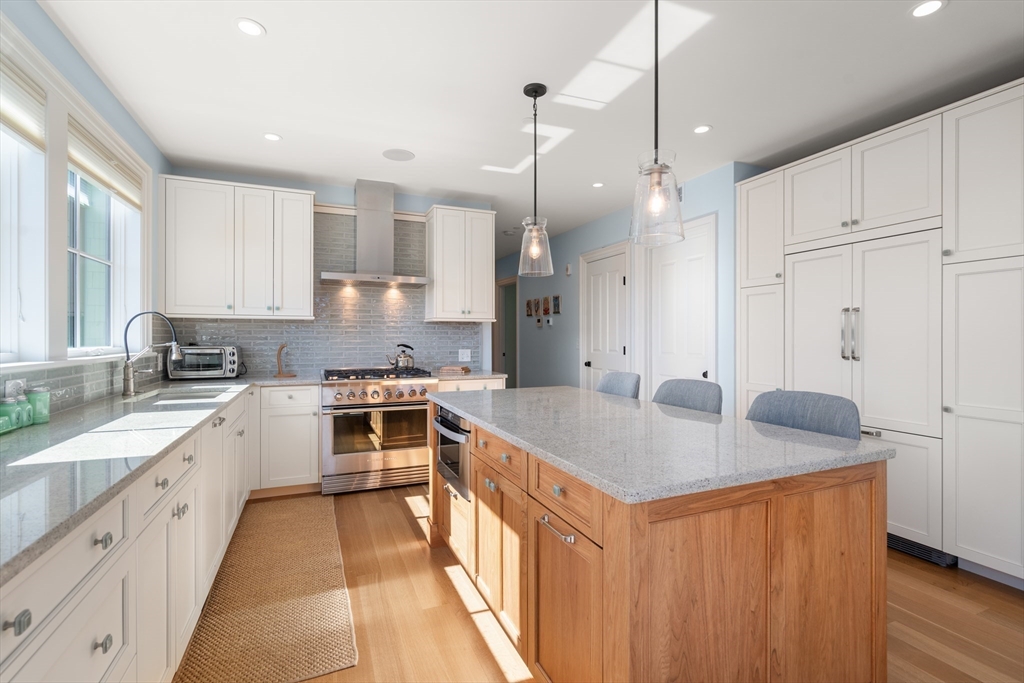 16 Everett Street, Unit 202 Boston, MA 02130 - Photo 7 of 19 a open kitchen with stainless steel appliances granite countertop a sink stove and refrigerator