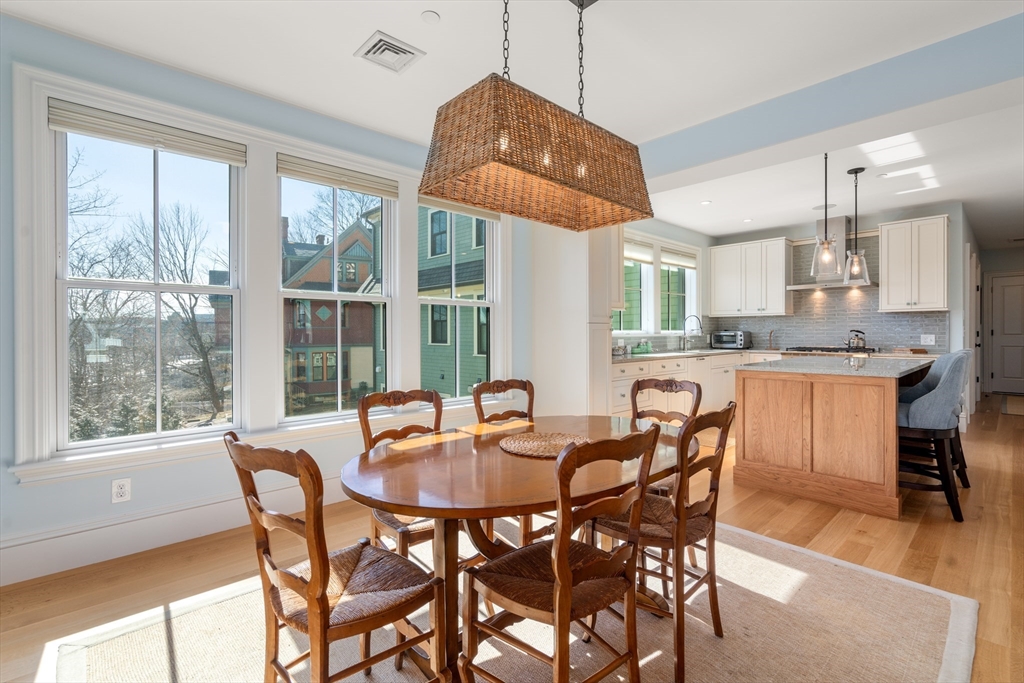 16 Everett Street, Unit 202 Boston, MA 02130 - Photo 8 of 19 a dining room with stainless steel appliances granite countertop a dining table and chairs
