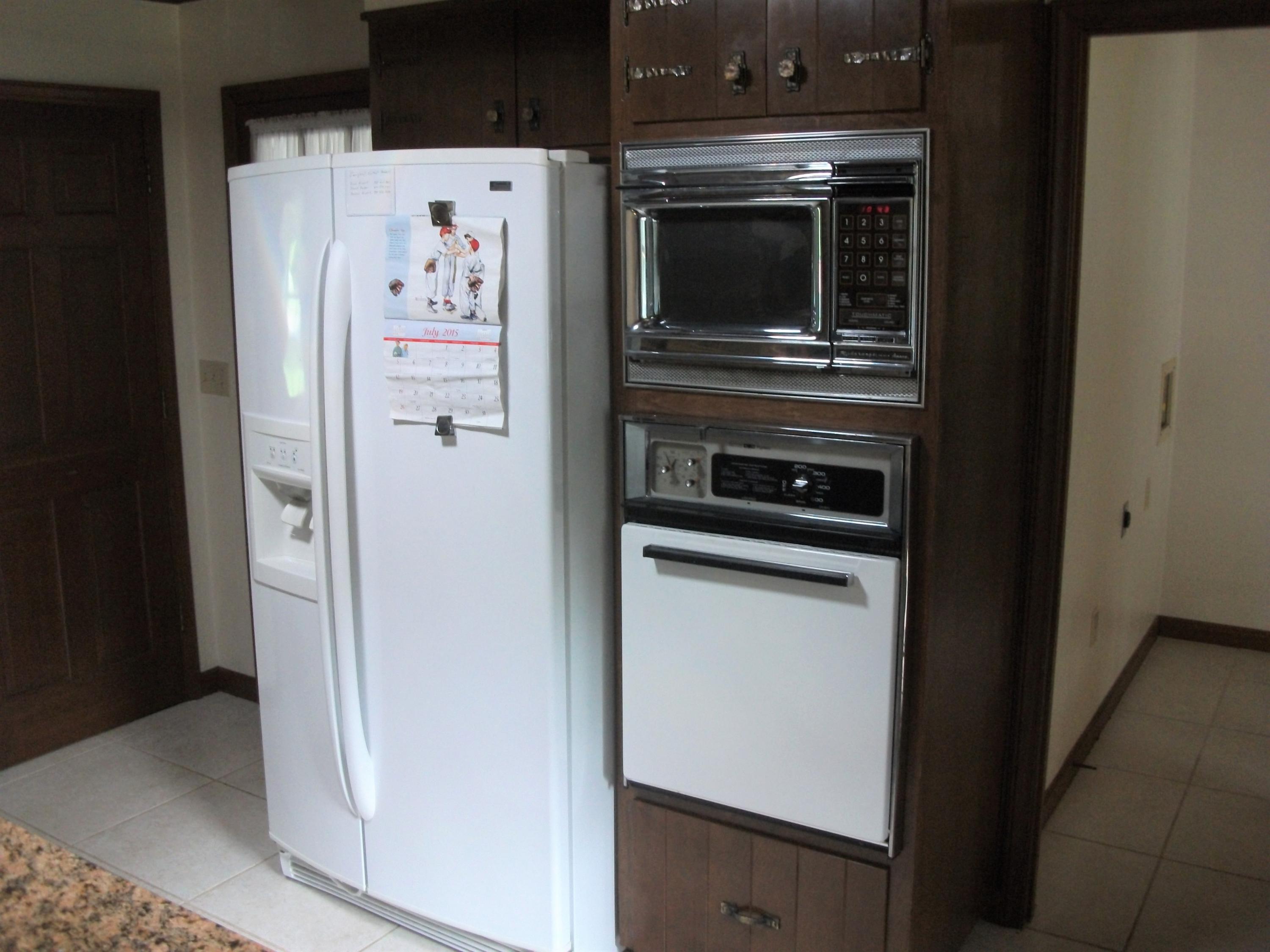 1958 Truevine Road Penhook, VA 24137 - Photo 12 of 45 a white refrigerator freezer and a stove sitting inside of a kitchen
