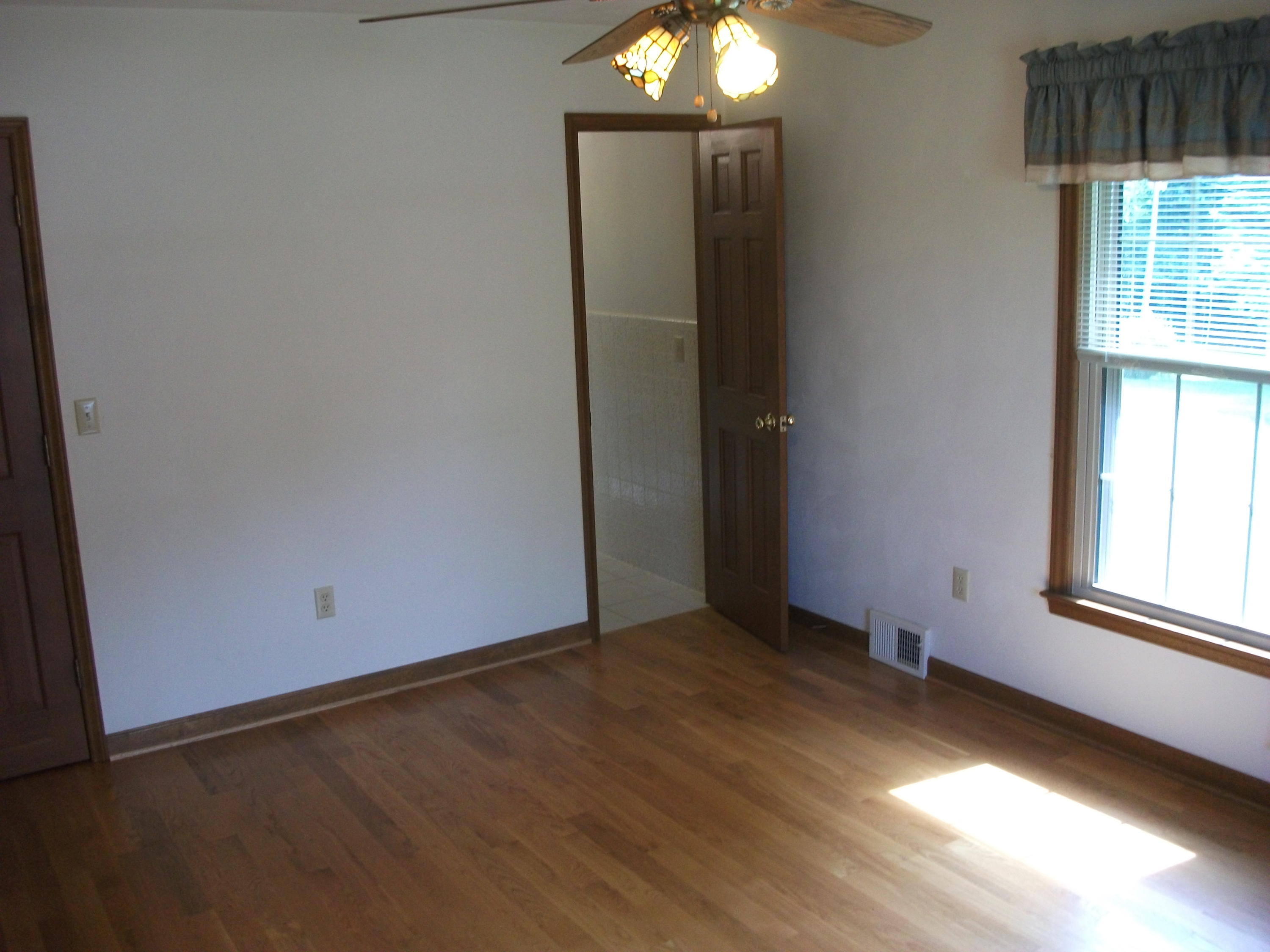 1958 Truevine Road Penhook, VA 24137 - Photo 15 of 45 an empty room with wooden floor and windows