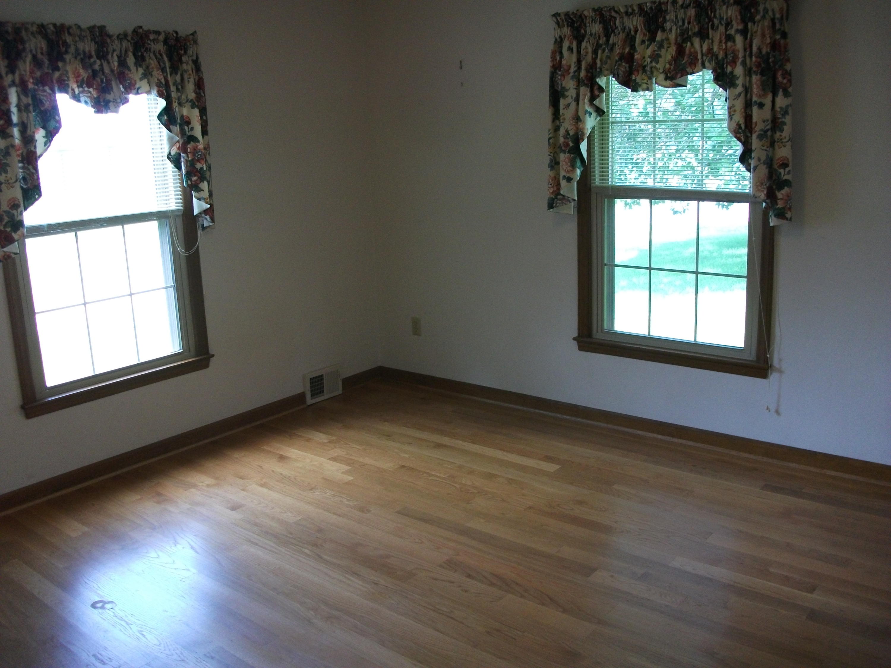 1958 Truevine Road Penhook, VA 24137 - Photo 18 of 45 an empty room with wooden floor windows and windows