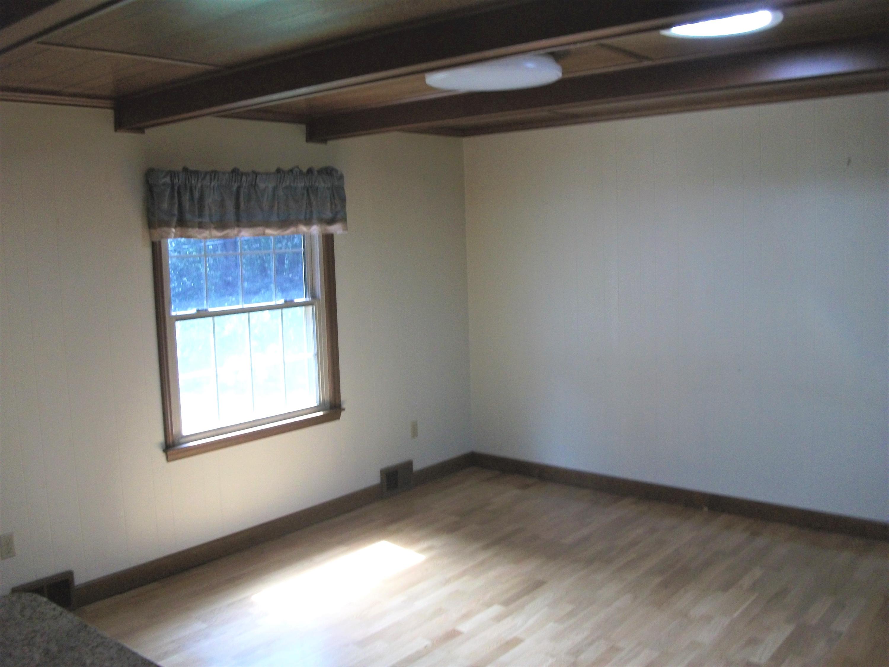 1958 Truevine Road Penhook, VA 24137 - Photo 6 of 45 a view of empty room with wooden floor and fan