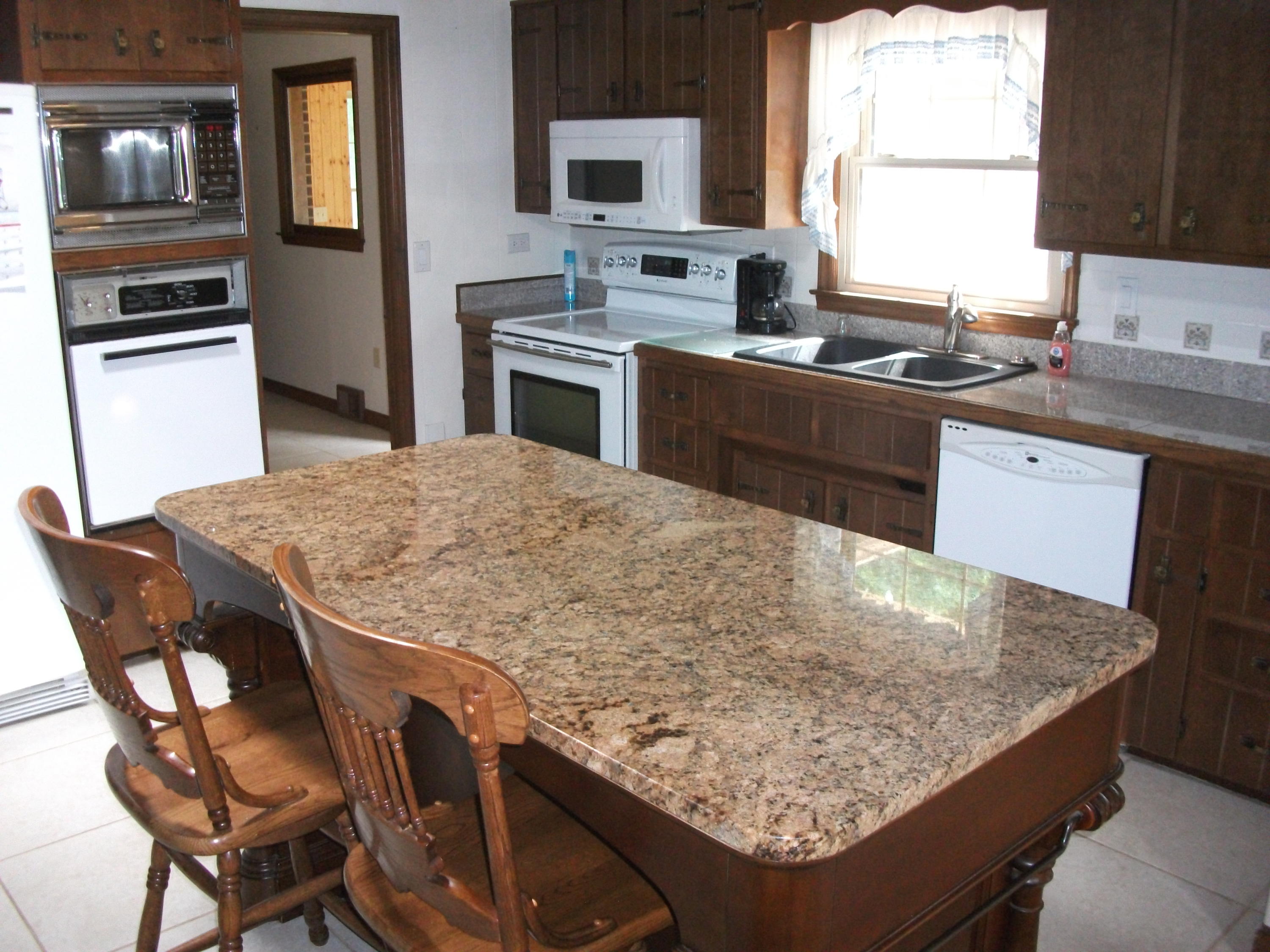 1958 Truevine Road Penhook, VA 24137 - Photo 10 of 45 a kitchen with granite countertop sink stove and refrigerator