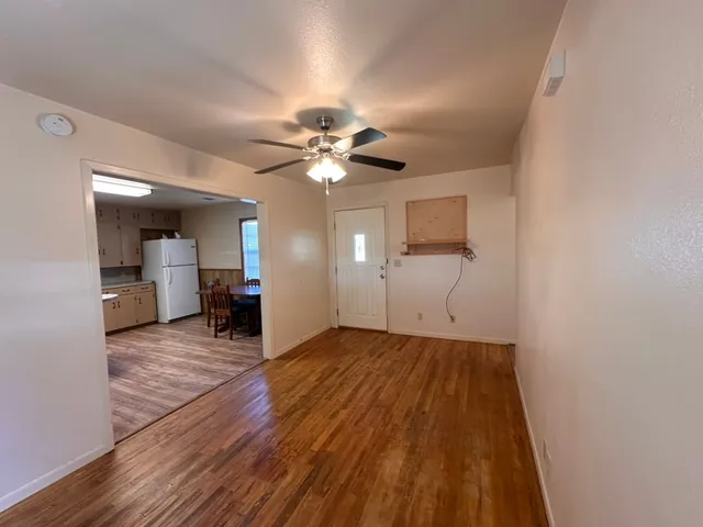 an empty room with closet and windows