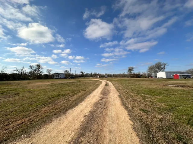 an empty room with wooden floor closet and windows