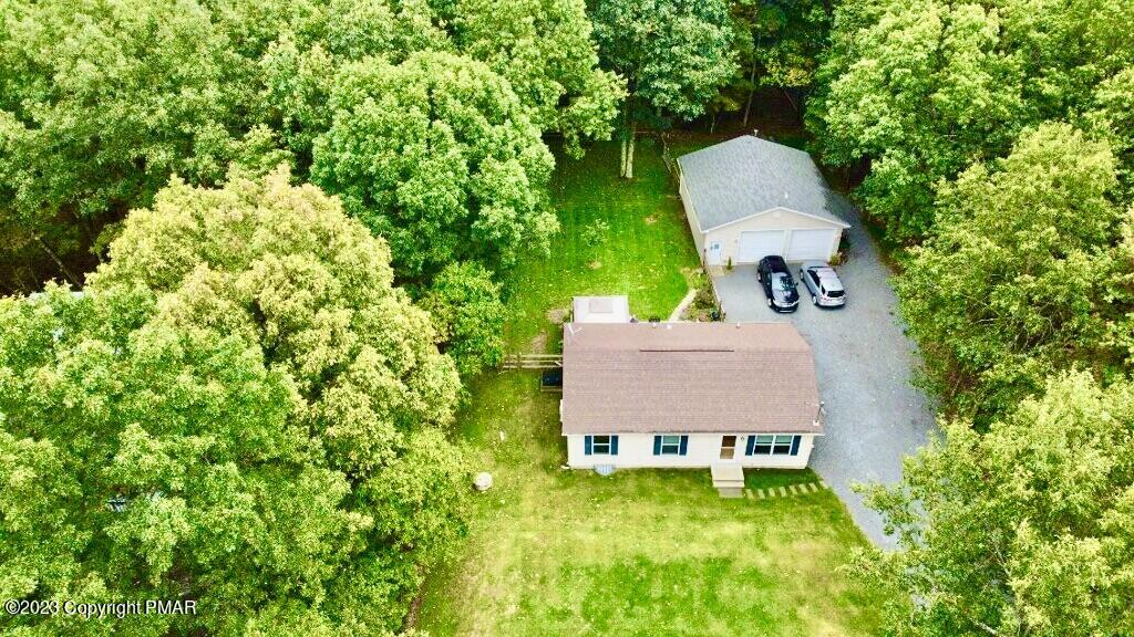 238 Schochs Mill Road Blakeslee, PA 18610 - Photo 1 of 13 an aerial view of a house with swimming pool and trees