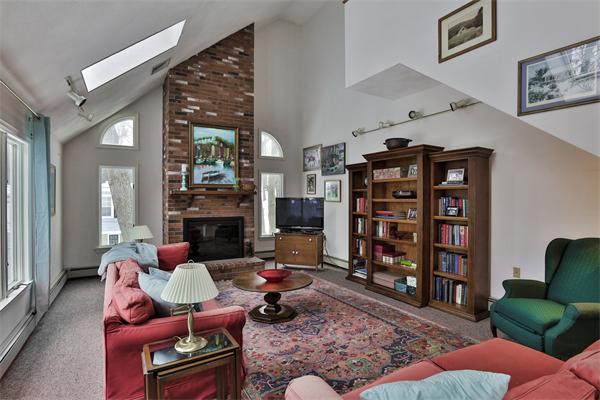 35 Lorena Road Winchester, MA 01890 - Photo 11 of 29 a living room with fireplace furniture and a book shelf