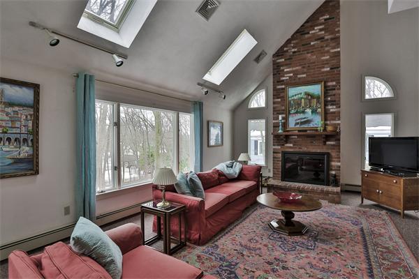 35 Lorena Road Winchester, MA 01890 - Photo 12 of 29 a living room with furniture a fireplace and a flat screen tv