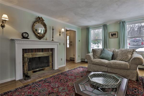 35 Lorena Road Winchester, MA 01890 - Photo 4 of 29 a living room with furniture a clock and a fireplace