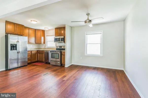 a kitchen with stainless steel appliances a stove a sink and a refrigerator