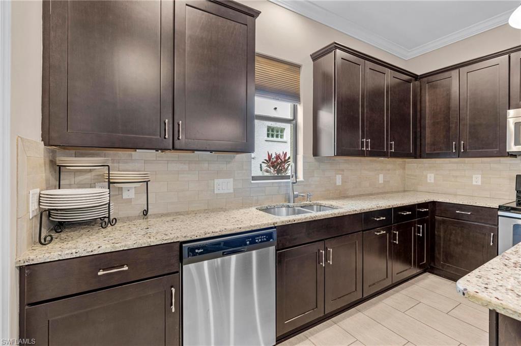 1300 Kendari Terrace Naples, FL 34113 - Photo 11 of 31 a kitchen with a sink and cabinets