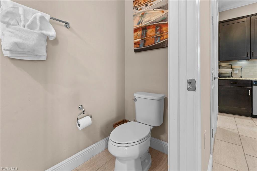 1300 Kendari Terrace Naples, FL 34113 - Photo 14 of 31 a white toilet sitting next to a bathroom sink