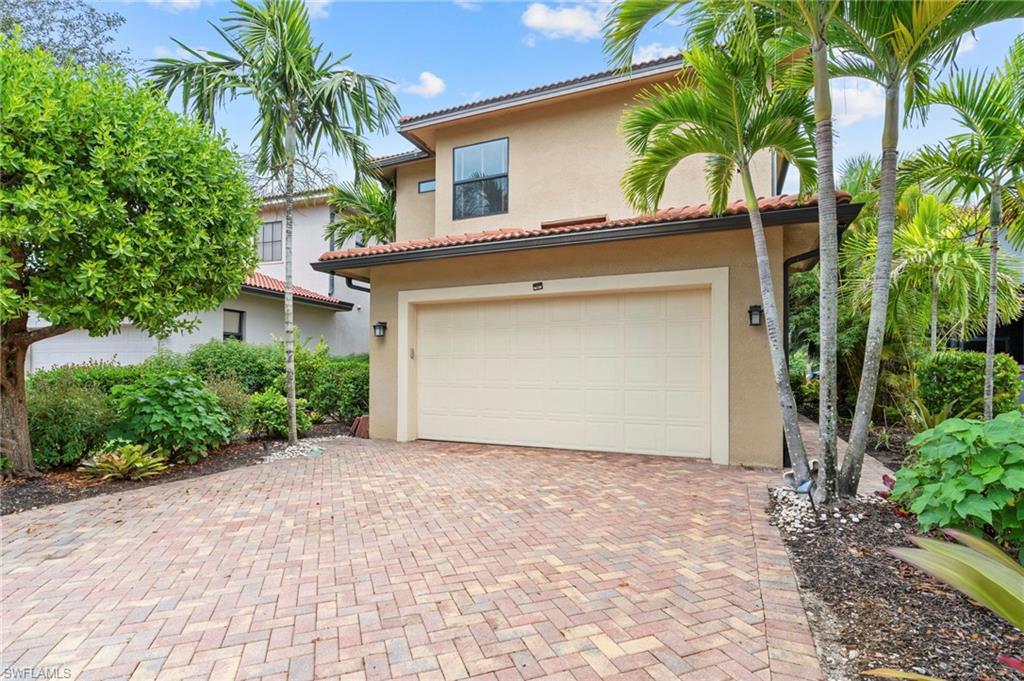 1300 Kendari Terrace Naples, FL 34113 - Photo 2 of 31 a front view of a house with a yard and a garage