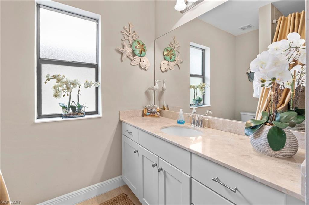 1300 Kendari Terrace Naples, FL 34113 - Photo 21 of 31 a bathroom with a sink and a mirror