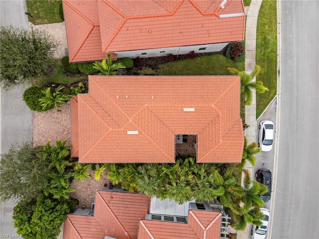 1300 Kendari Terrace Naples, FL 34113 - Photo 31 of 31 an aerial view of a house with a yard and a bench