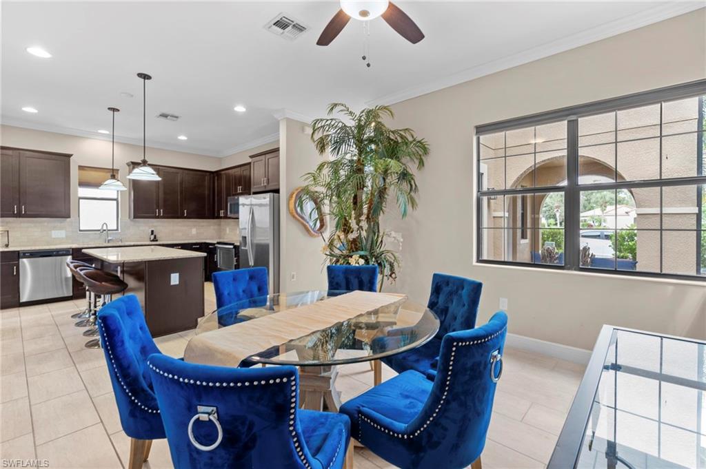 1300 Kendari Terrace Naples, FL 34113 - Photo 8 of 31 a view of a dining room with furniture window and outside view