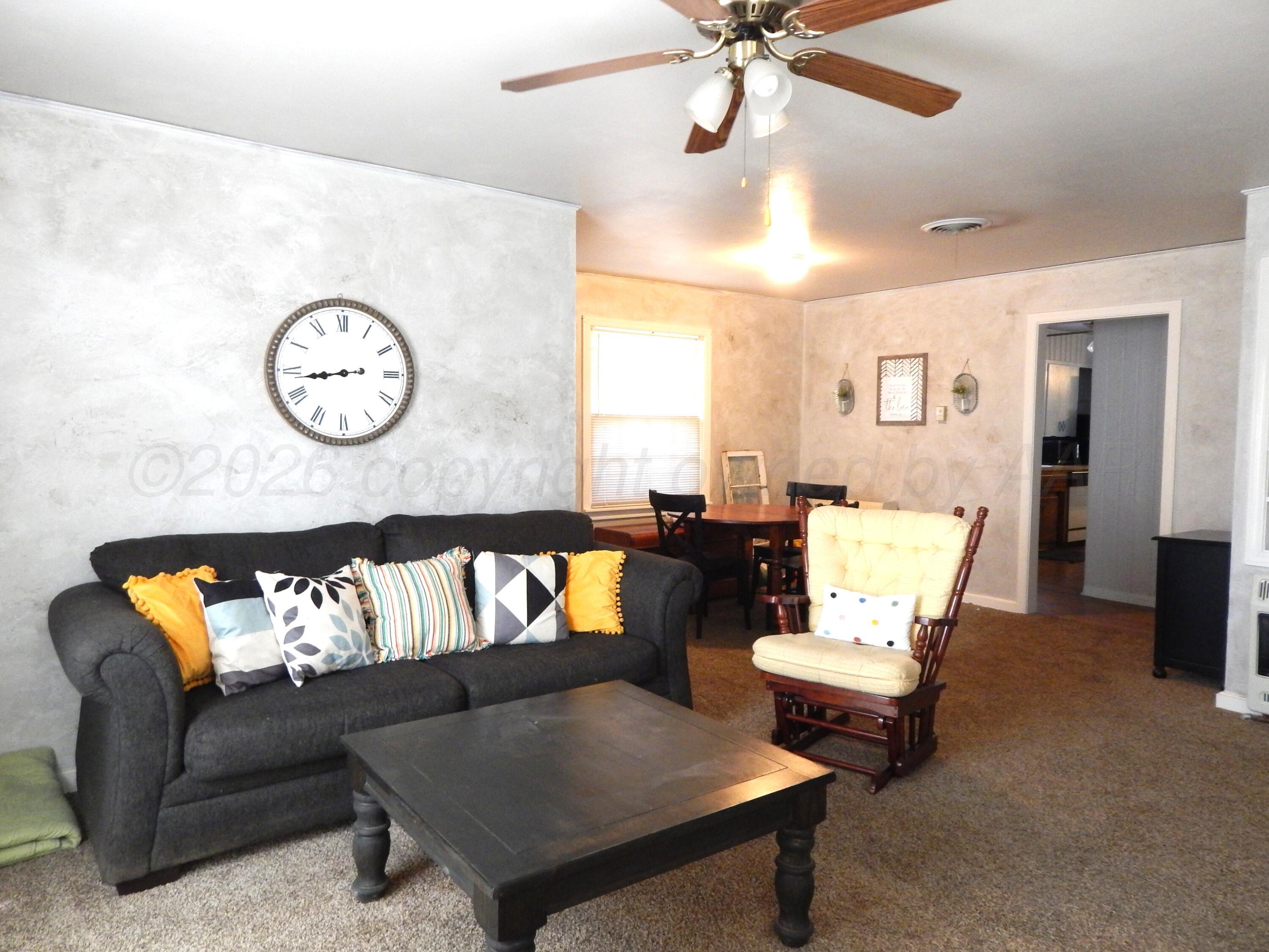 519 Third Street McLean, TX 79057 - Photo 2 of 19 a living room with furniture and a large window