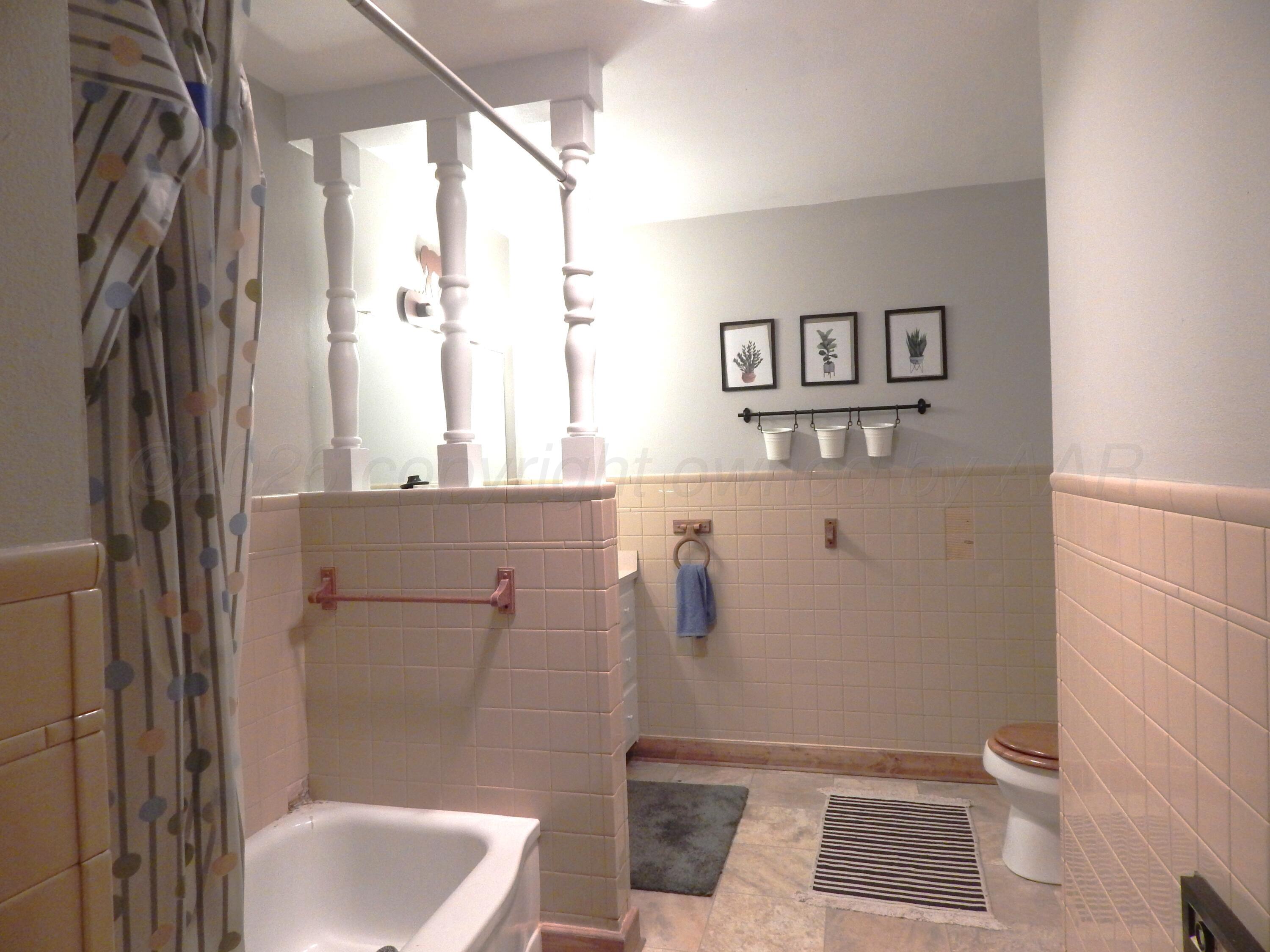 519 Third Street McLean, TX 79057 - Photo 8 of 19 a bathroom with a shower and a toilet