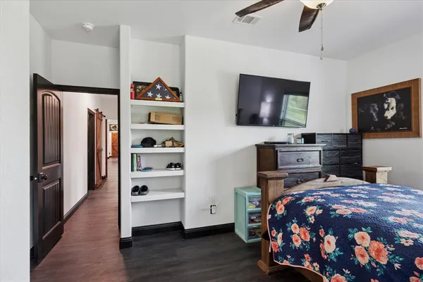 a bedroom with a bed and a flat screen tv