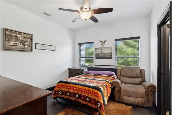a bedroom with a bed couch and window