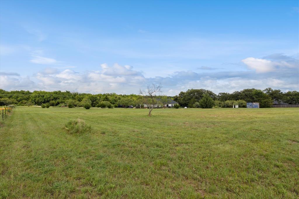 403 Polk Road Bowie, TX 76230 - Photo 29 of 36 View of grassy yard featuring a rural view