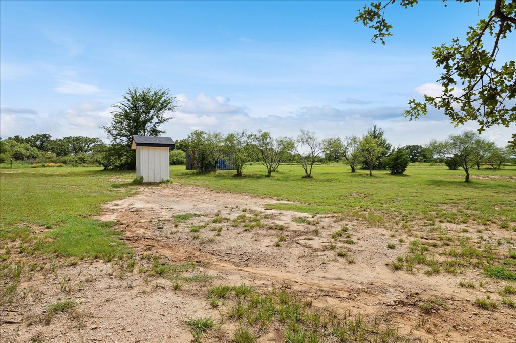 403 Polk Road Bowie, TX 76230 - Photo 30 of 36 View of yard with a storage shed and a view of countryside