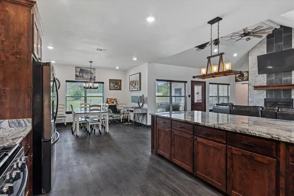 a kitchen with lots of counter space and painting on the wall