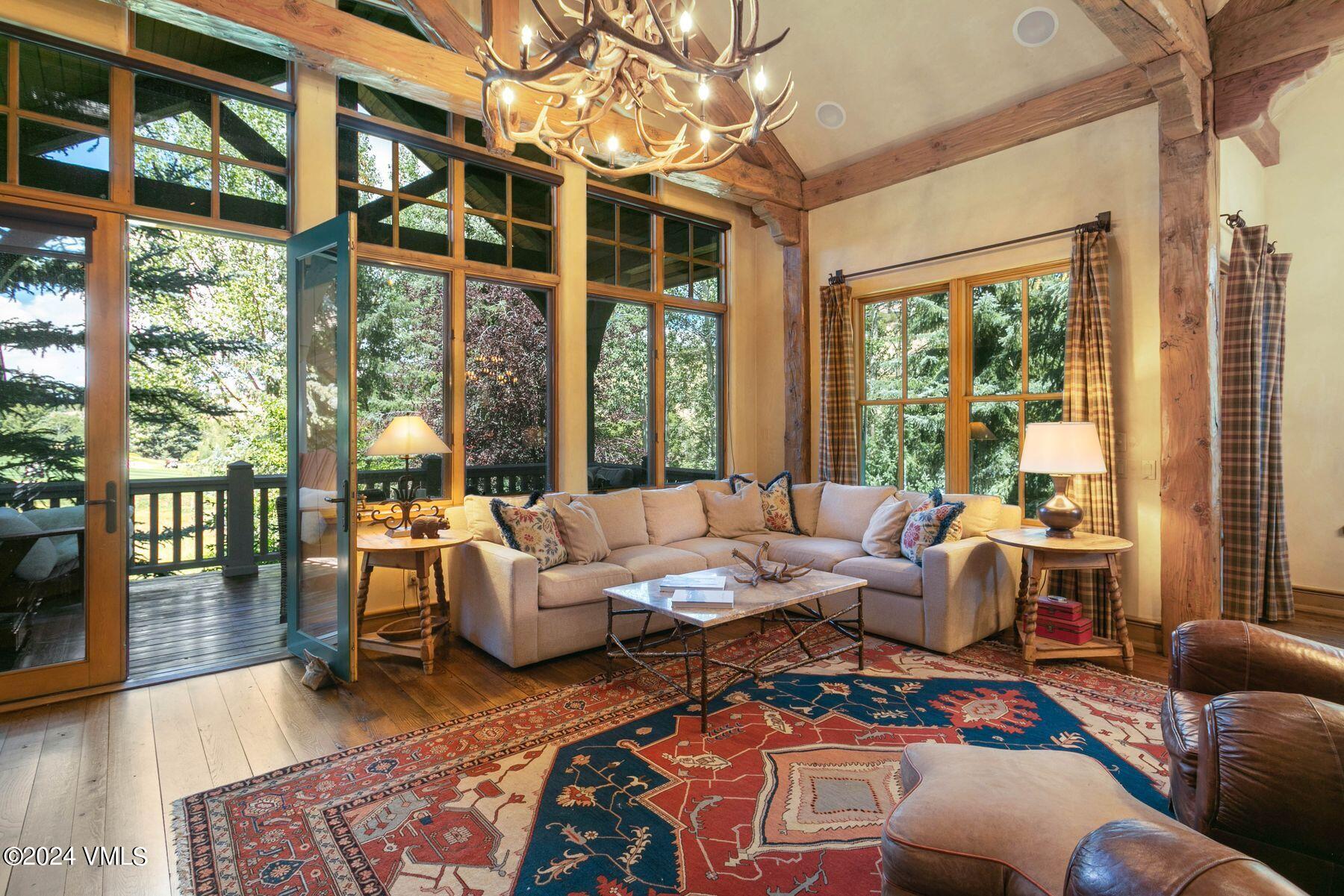 a living room with furniture and large windows