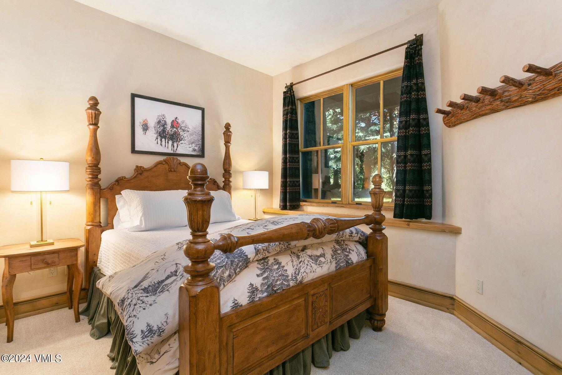90 Riverbend Court, Unit E Edwards, CO 81632 - Photo 22 of 35 a bed sitting in a bedroom next to a window