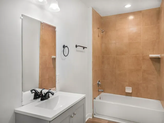 a bathroom with a sink a bathtub and a shower