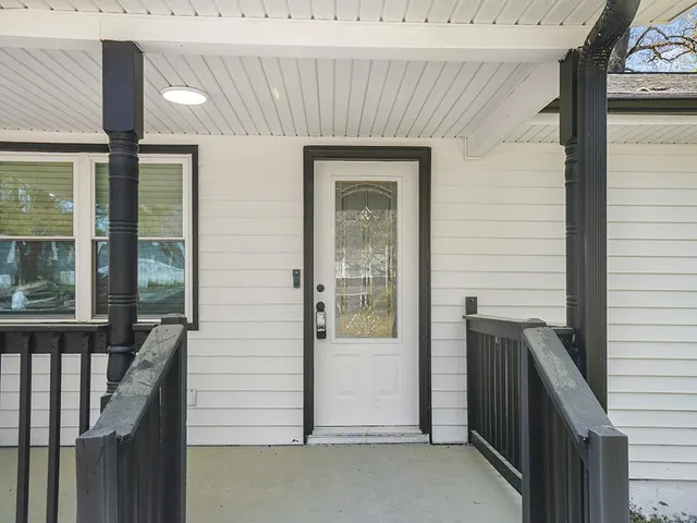 a view of a door and a window of the house