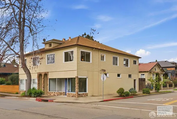a front view of a house with a garden