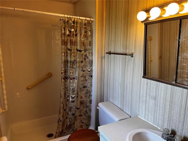 a bathroom with a shower and a sink