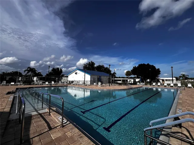 a view of a swimming pool and lounge chairs