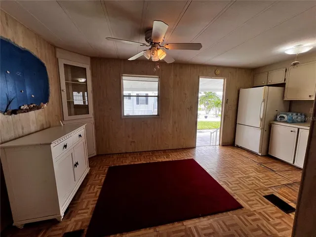 a view of a kitchen with a sink and a refrigerator