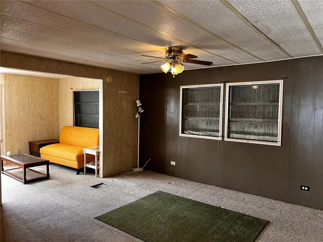 a view of a livingroom with furniture and a ceiling fan